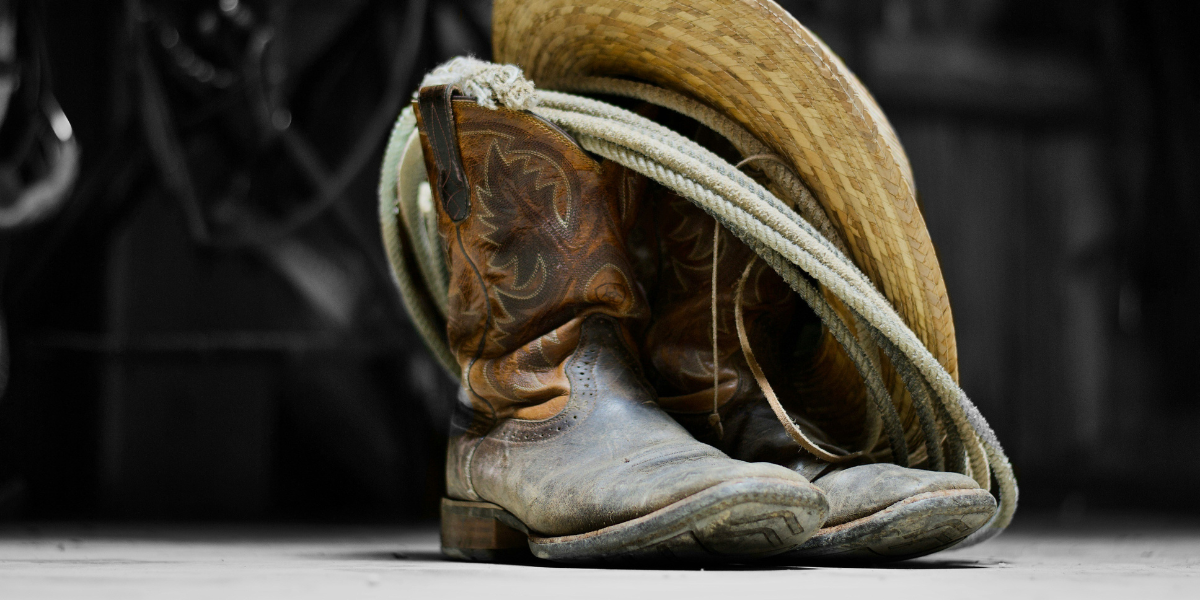 cowboy boots, a hat and rope